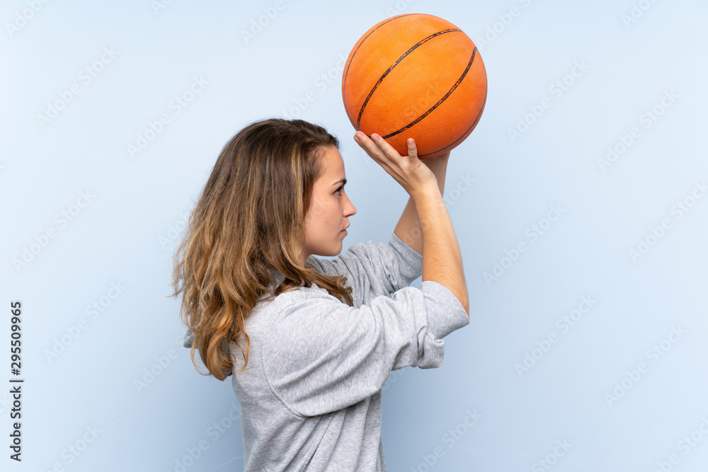 Young blonde woman with ball of basketball Young blonde woman with ball of basketball