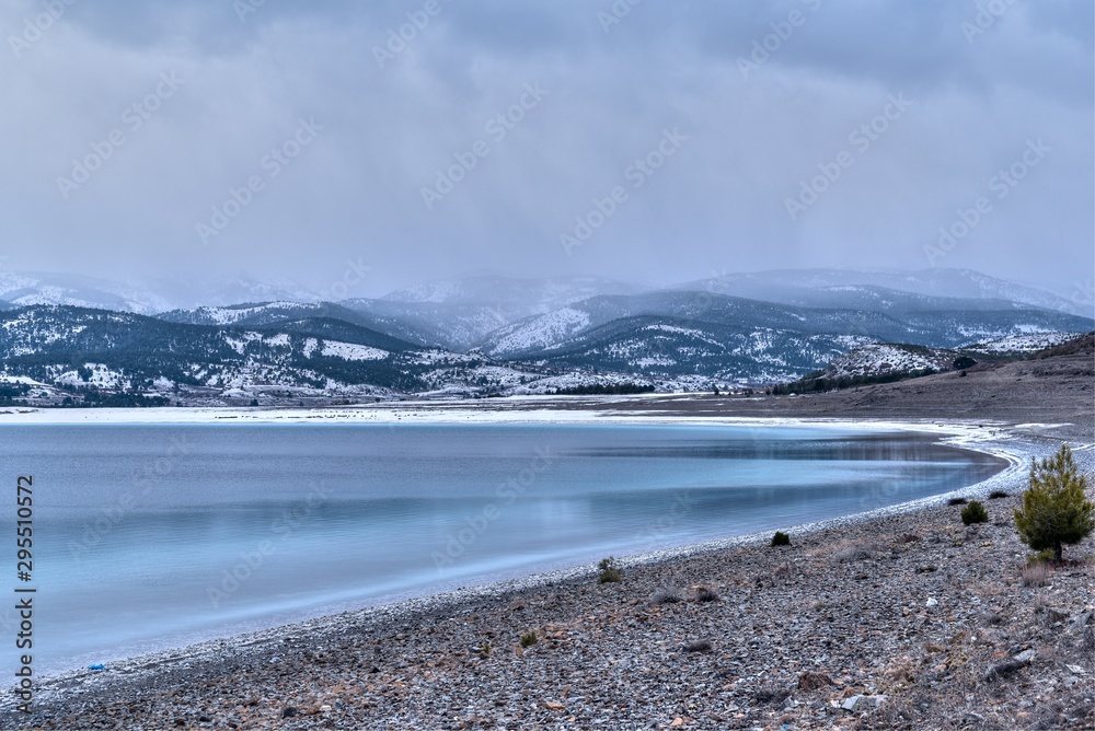 Beautiful winter landscape scene of a snowy lake at winter, Salda Lake, Turkey