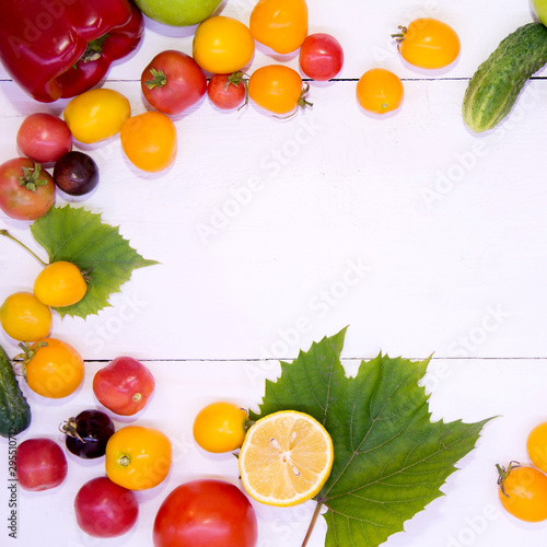 Fototapeta Naklejka Na Ścianę i Meble -  Background with vegetables. Vegetables on a white background wood texture top view. Tomatoes cucumbers peppers apples. Proper nutrition and diet. Concept of vegetarianism and detox.