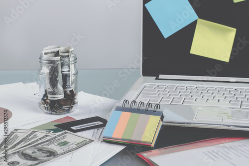 Business table with office supplies. Save money is a good idea. Economic concept photo