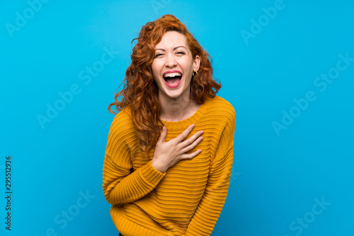 Redhead woman with yellow sweater smiling a lot photo