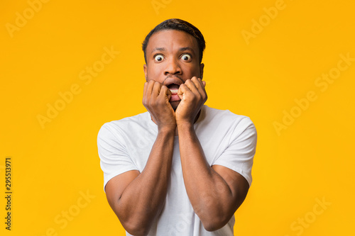 Scared African American Man Looking At Camera Standing, Studio Shot