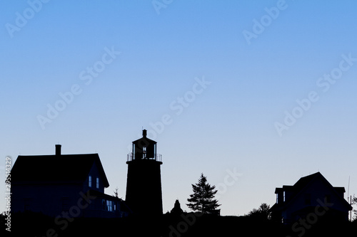 Lighthouse silhouette on blue
