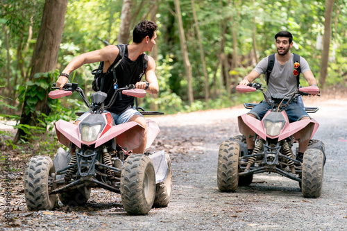 Atv riders speed race to journey through the jungle with Off-road atv car. © pigprox