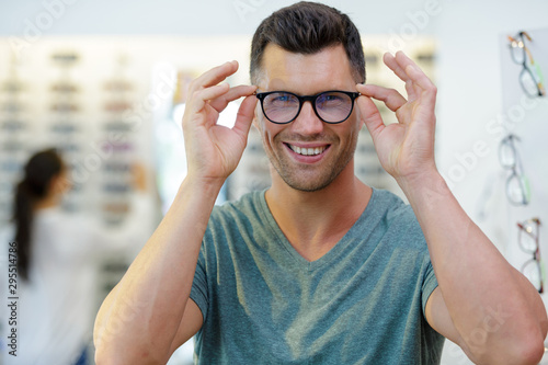 smiling man wearing eyeglasses in optical shop