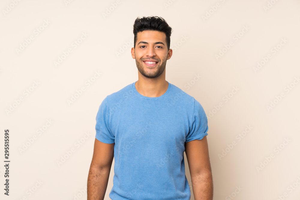 Young handsome man over isolated background keeping the arms crossed in frontal position - obrazy, fototapety, plakaty 
