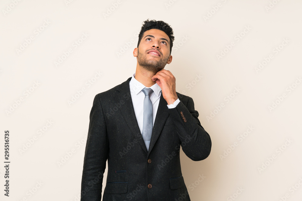 Young handsome businessman man over isolated background thinking an idea Young handsome businessman man over isolated background thinking an idea