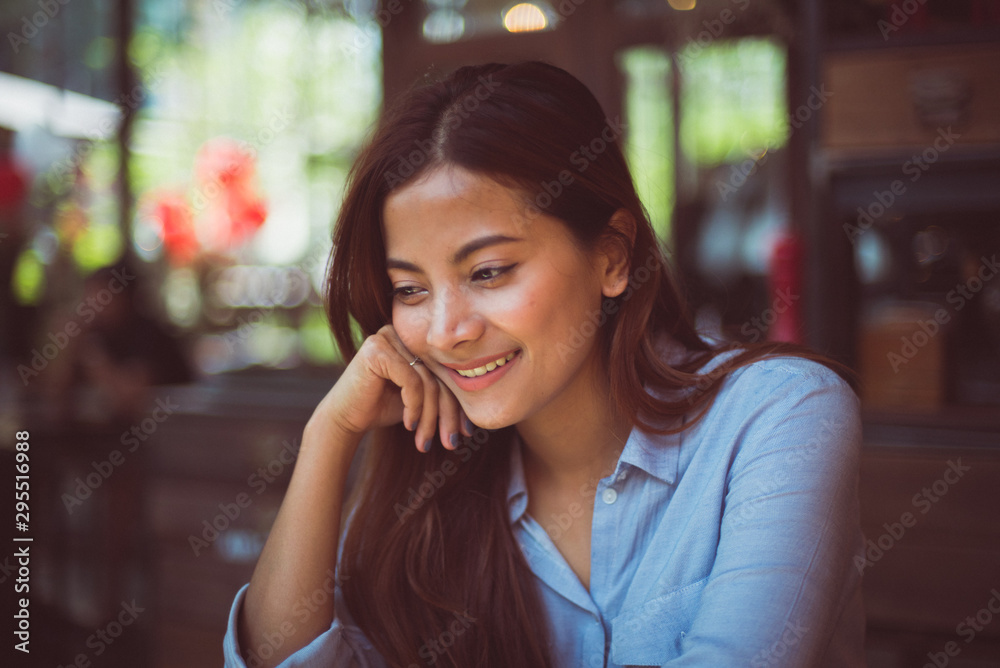 Fototapeta premium Asian woman drinking coffee in vintage color tone