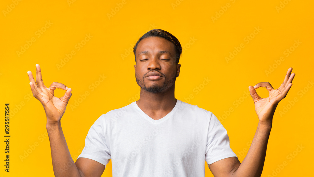 Black Man Meditating Standing Over Yellow Background, Panorama Black Man Meditating Standing Over Yellow Background, Panorama