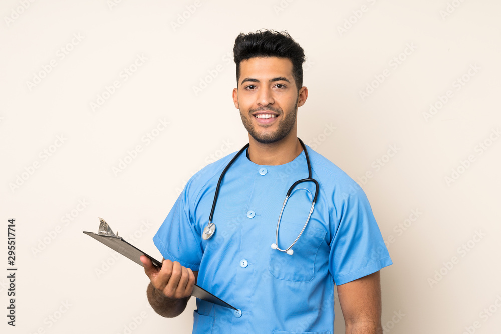 Young handsome man over isolated background with doctor gown and holding a folder Young handsome man over isolated background with doctor gown and holding a folder
