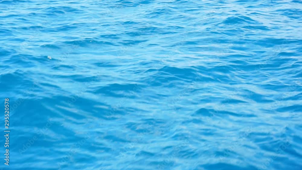 The surface of the blue sea, ocean waves on a sunny day with sunlight on the surface. Background of blue ocean surface.1920X1080 Full Hd. The surface of the blue sea, ocean waves on a sunny day with sunlight on the surface. Background of blue ocean surface.1920X1080 Full Hd.