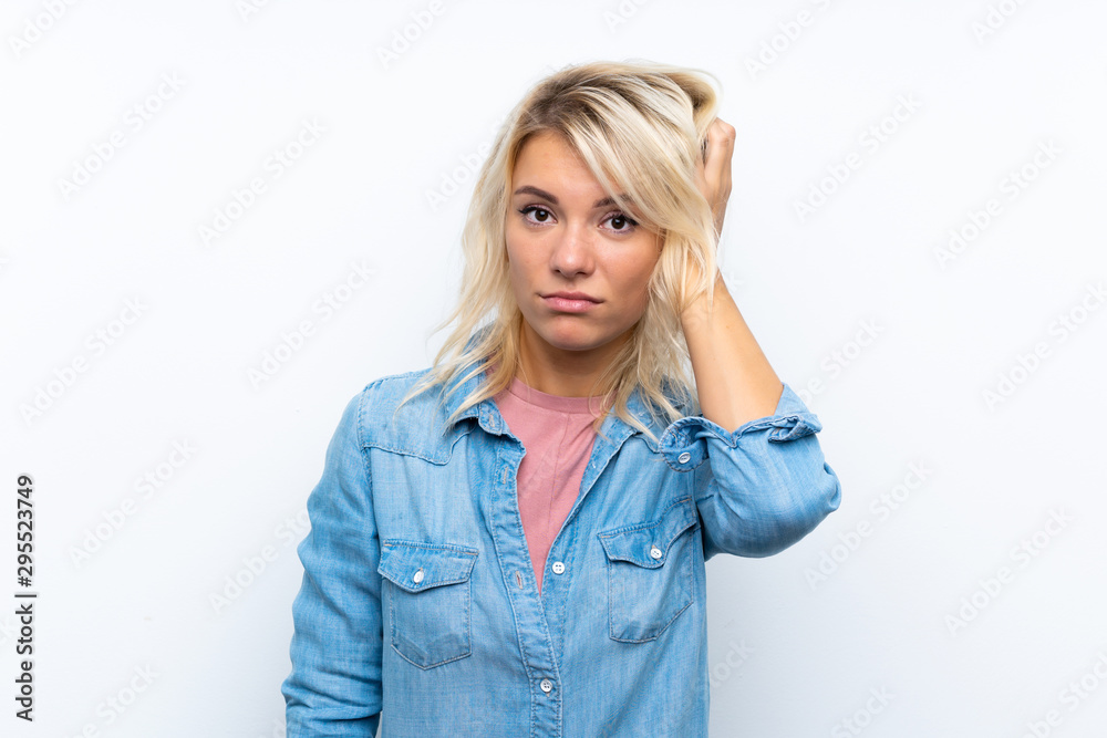 Young blonde woman over isolated white background with an expression of frustration and not understanding Young blonde woman over isolated white background with an expression of frustration and not understanding