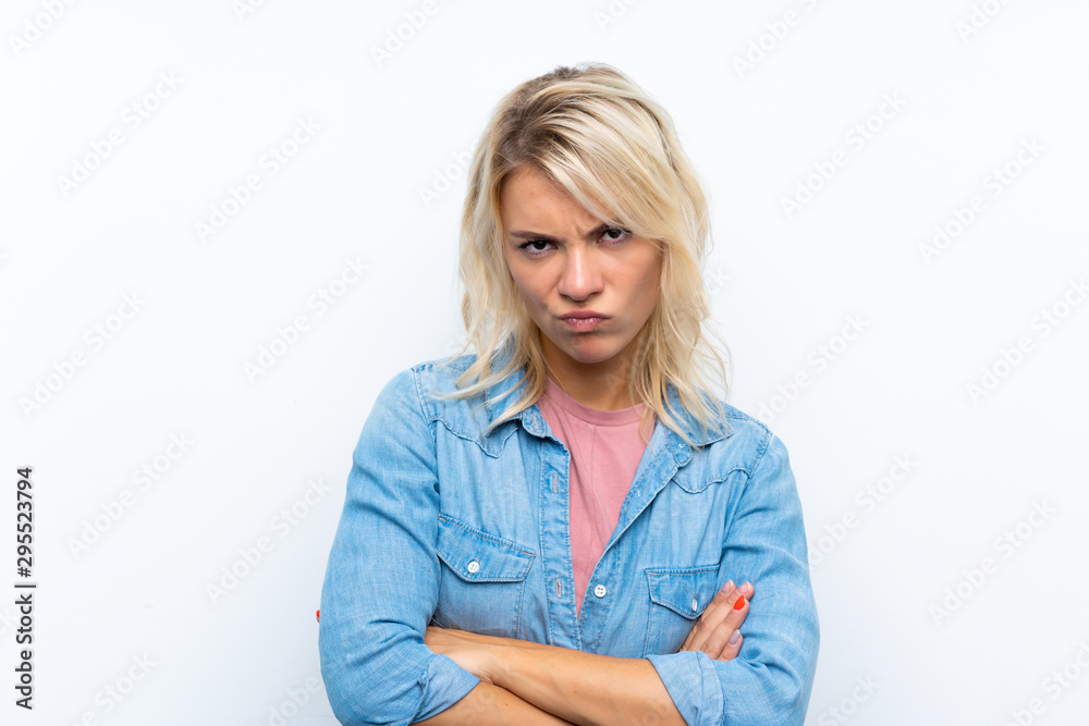 Young blonde woman over isolated white background feeling upset Young blonde woman over isolated white background feeling upset