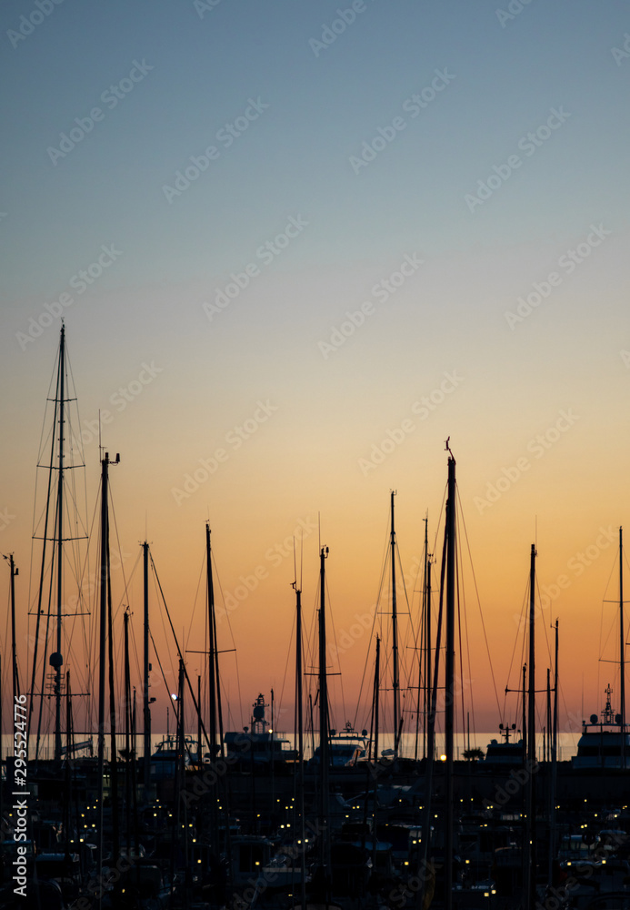 Sailboats in the harbor at dusk