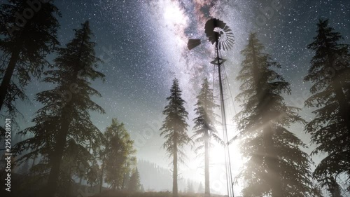 retro windmill in mountain forest with stars. hyperlapse photo