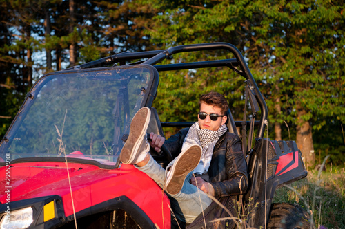 portrait of young man driving a off road buggy car