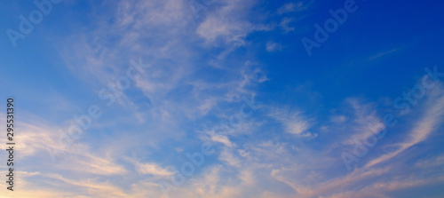 Fluffy clouds in the blue sky. Wide photo.