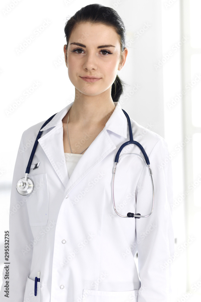 Doctor woman cheerful smiling at camera. Perfect medical service in clinic. Happy future in medicine and healthcare Doctor woman cheerful smiling at camera. Perfect medical service in clinic. Happy future in medicine and healthcare