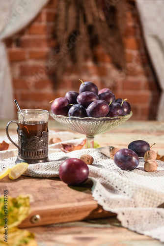 Tea and glass of plums
