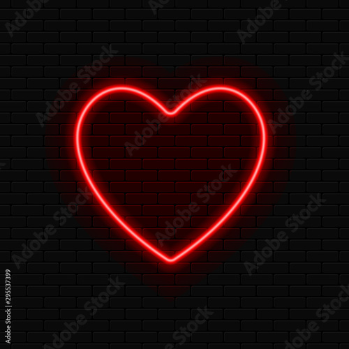 Neon heart. Brightly red neon sign with night illumination on a black brick wall.