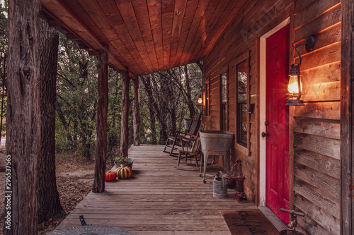 Front porch of a cabin in the woods at dawn