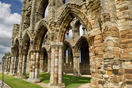 Eroded stones and pillars of the Gothic ruins of Whitby Abbey church chancel North York Moors National Park England