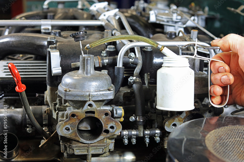 Drop Of Oil Being Added To A Engine Carburettor On A Classic Car Drop Of Oil Being Added To A Engine Carburettor On A Classic Car