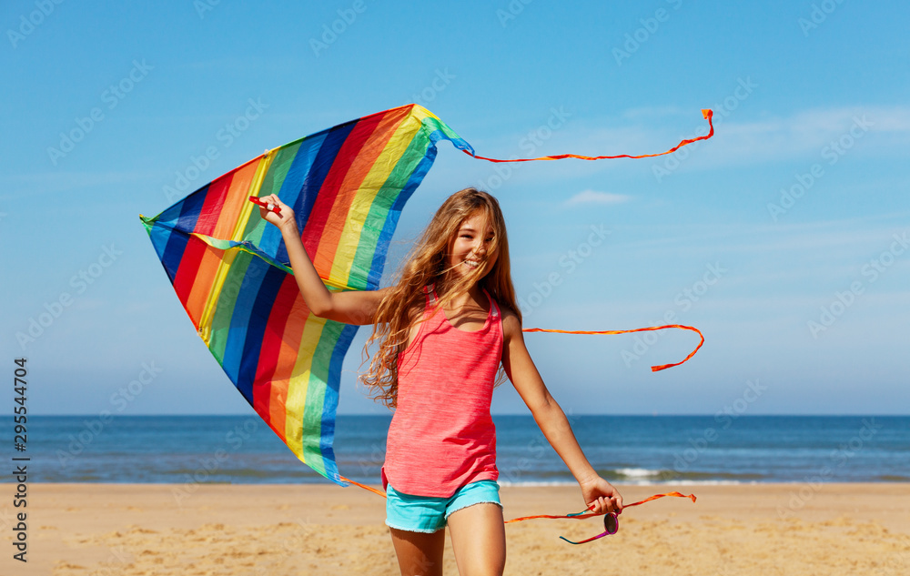 Beautiful girl play with colorful bright kite