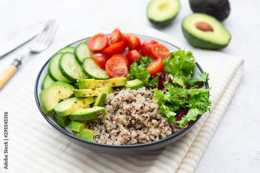Healthy food. budha bowl with quinoa, avocado, cucumber, salad, tomatoe, olive oil. Clean eating, diet food. Bright background. Healthy food. budha bowl with quinoa, avocado, cucumber, salad, tomatoe, olive oil. Clean eating, diet food. Bright background.