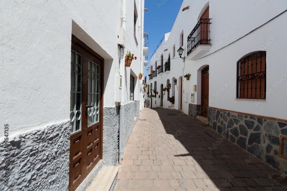 Fototapeta premium Mojacar, Spain - Narrow Street with White Buildings