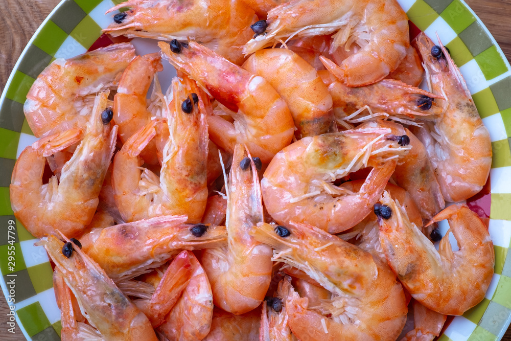 boiled shrimp lie on a plate. these shrimp are unpeeled boiled shrimp lie on a plate. these shrimp are unpeeled