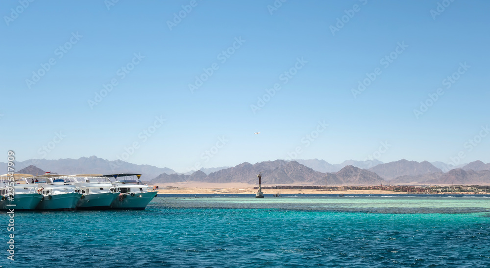 White yachts tourists in Red sea Tiran island Bay Akaba near Sharm El Sheikh in Egypt
