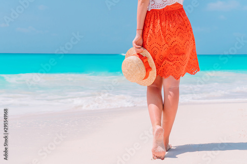 Close up of female feet on white sand beach photo