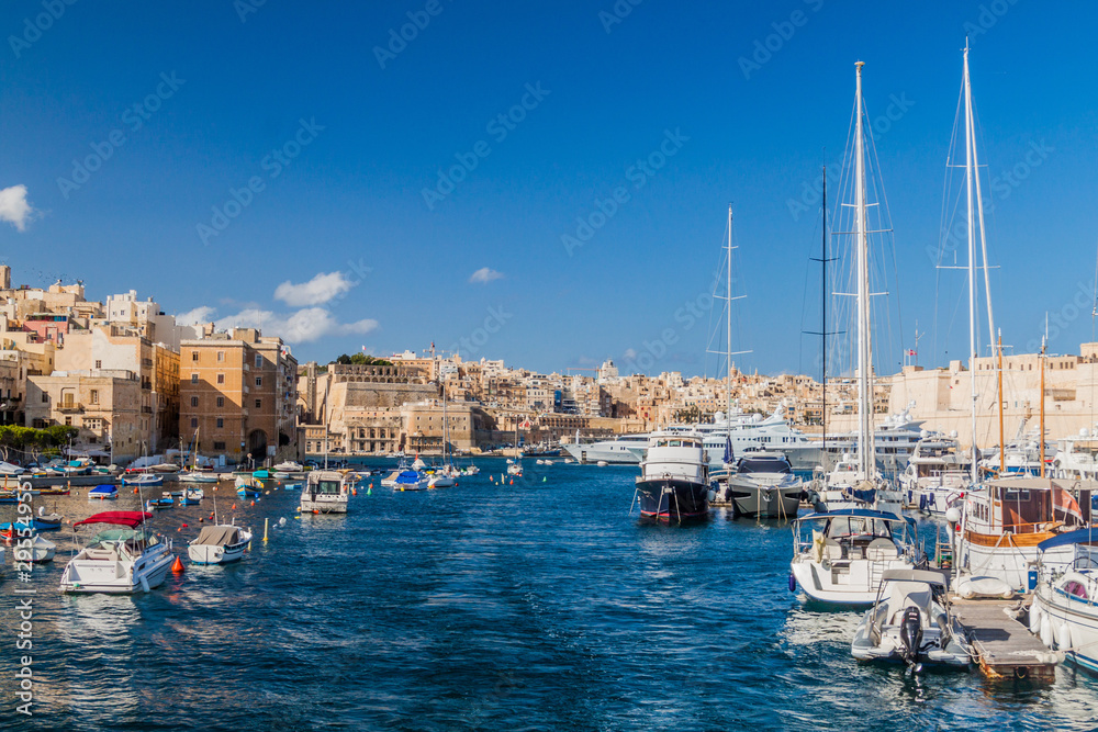 Boats between Senglea and Birgu towns, Valletta in the background.