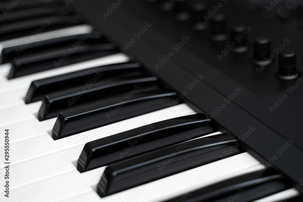 Professional midi keyboard synthesizer with knobs and controllers.