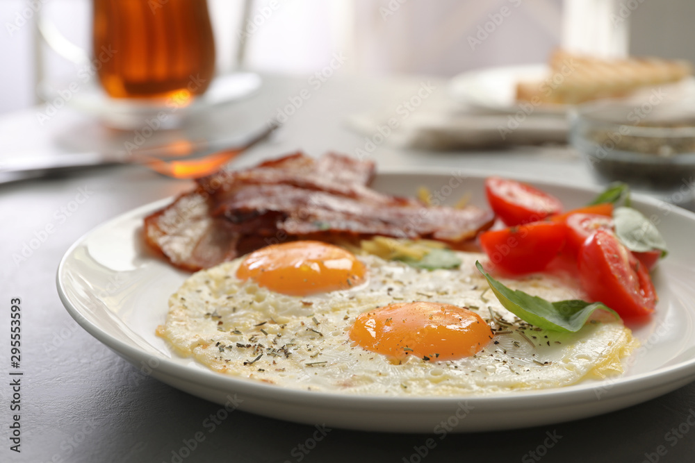 Tasty breakfast with fried eggs on grey table, closeup