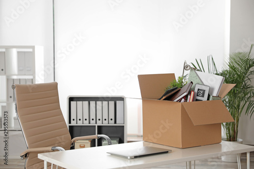 Cardboard box full of stuff on table in office © New Africa