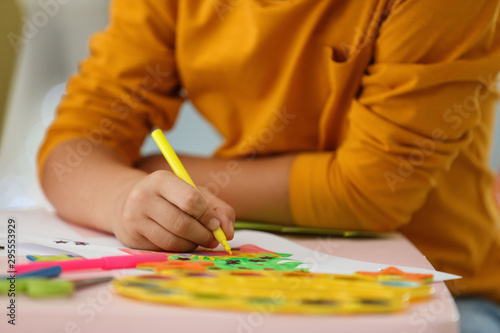 Little child drawing at table indoors, closeup. Christmas season