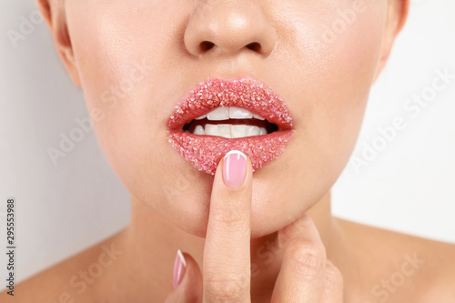 Young woman with sugar lips on white background  closeup