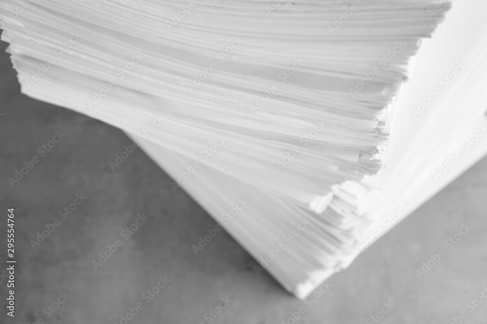 Fototapeta premium Stack of blank paper on grey stone table, above view