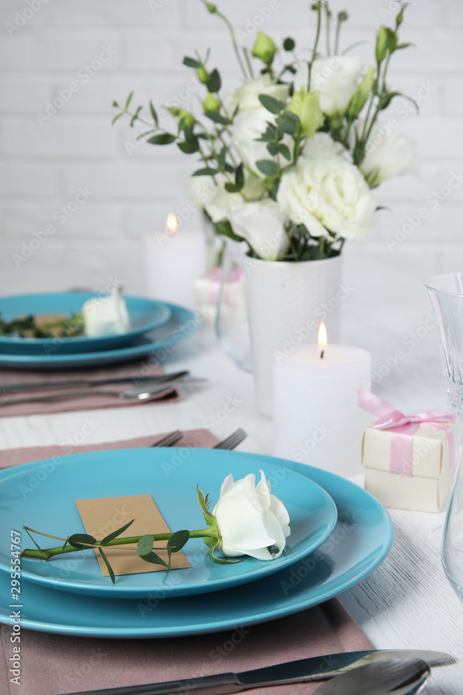 Elegant festive table setting with blank card in restaurant