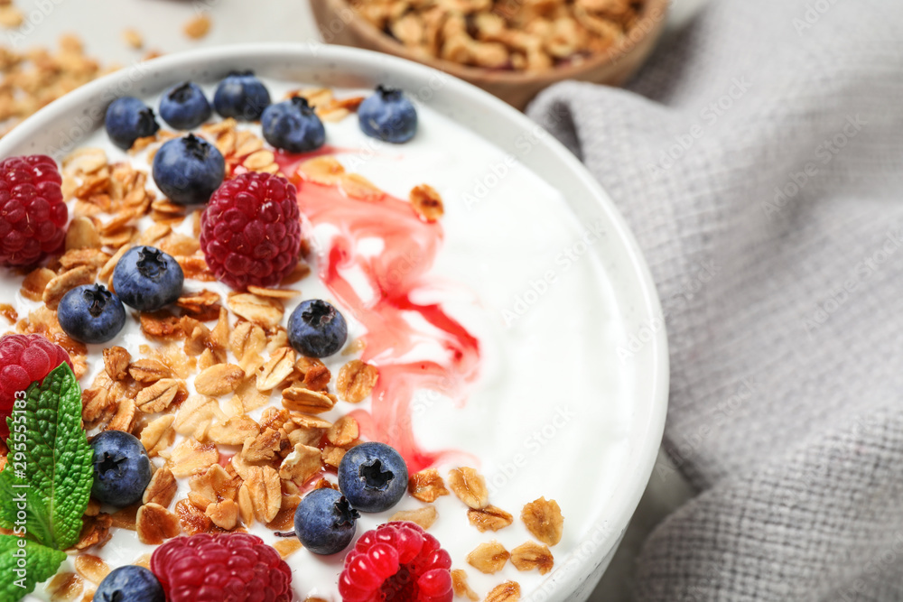 Tasty homemade granola with yogurt and berries on table, closeup. Healthy breakfast Tasty homemade granola with yogurt and berries on table, closeup. Healthy breakfast