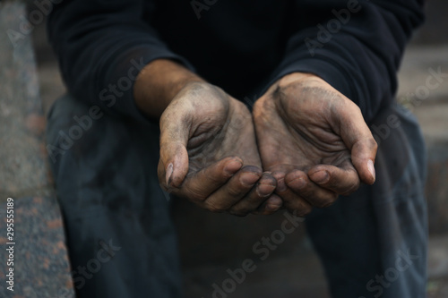 Poor homeless man begging for help outdoors, closeup