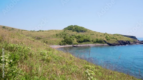 Wallpaper Mural Beautiful summer seascape. Beautiful views of the rocky coast of the turquoise sea and green grass. Torontodigital.ca