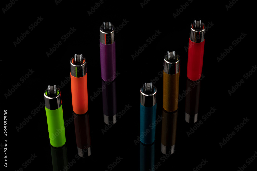 Multicolor gas lighters on black background Multicolor gas lighters on black background