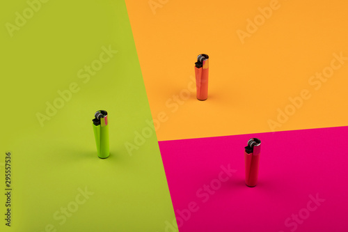 Multicolor gas lighters on colorful background