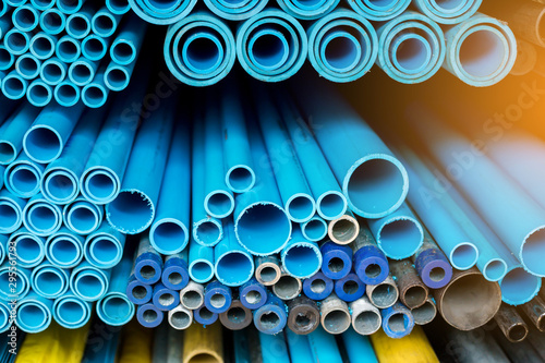 Close up to blue plastic pipe background, PVC pipes stacked in warehouse.