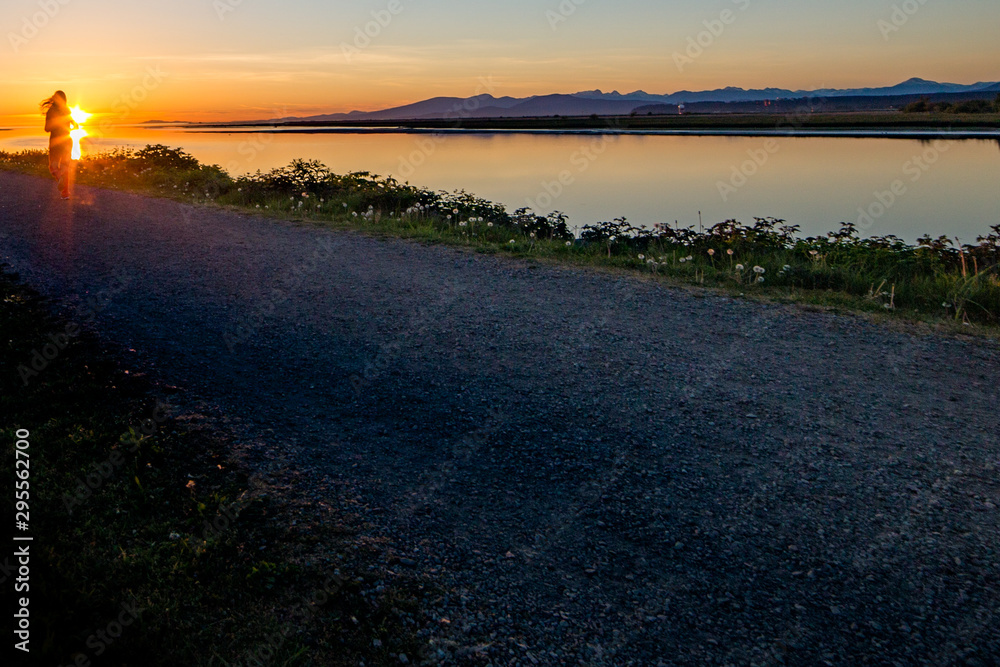 Sunset silhouette of person jogging Richmond, B.C.