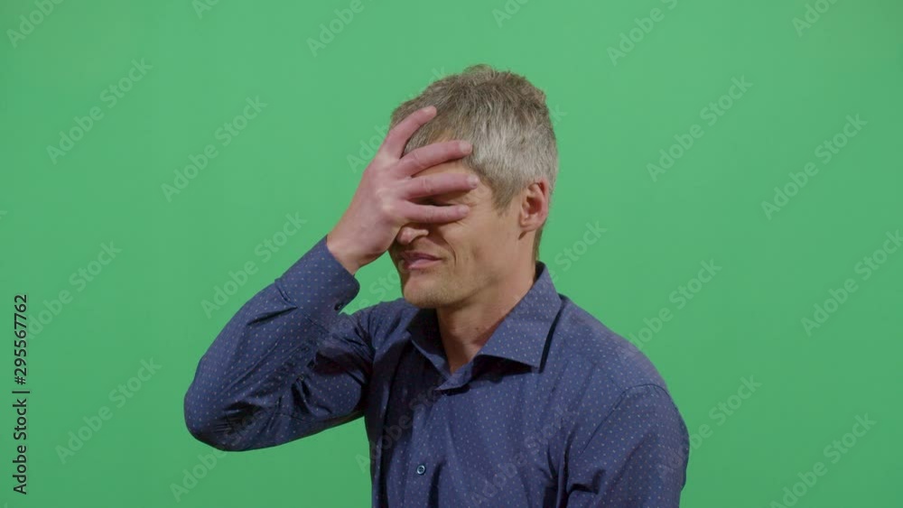 Adult Man Slapping His Forehead Suggesting Bad News Notice. Studio Isolated Shot Against Green Screen Background Adult Man Slapping His Forehead Suggesting Bad News Notice. Studio Isolated Shot Against Green Screen Background