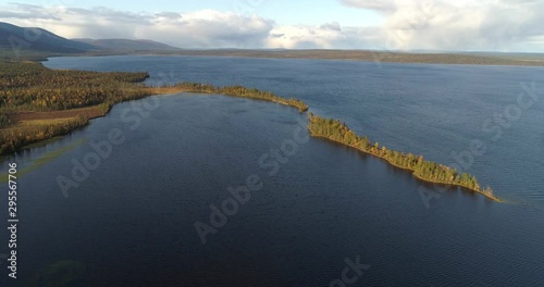 Pallasjarvi, Aerial, pan, drone shot, overlooking a esker and islands, full of autum color trees, on a lake, on a sunny, fall day, in Pallas-Yllas national park, Muonio, Lapland, Finland photo